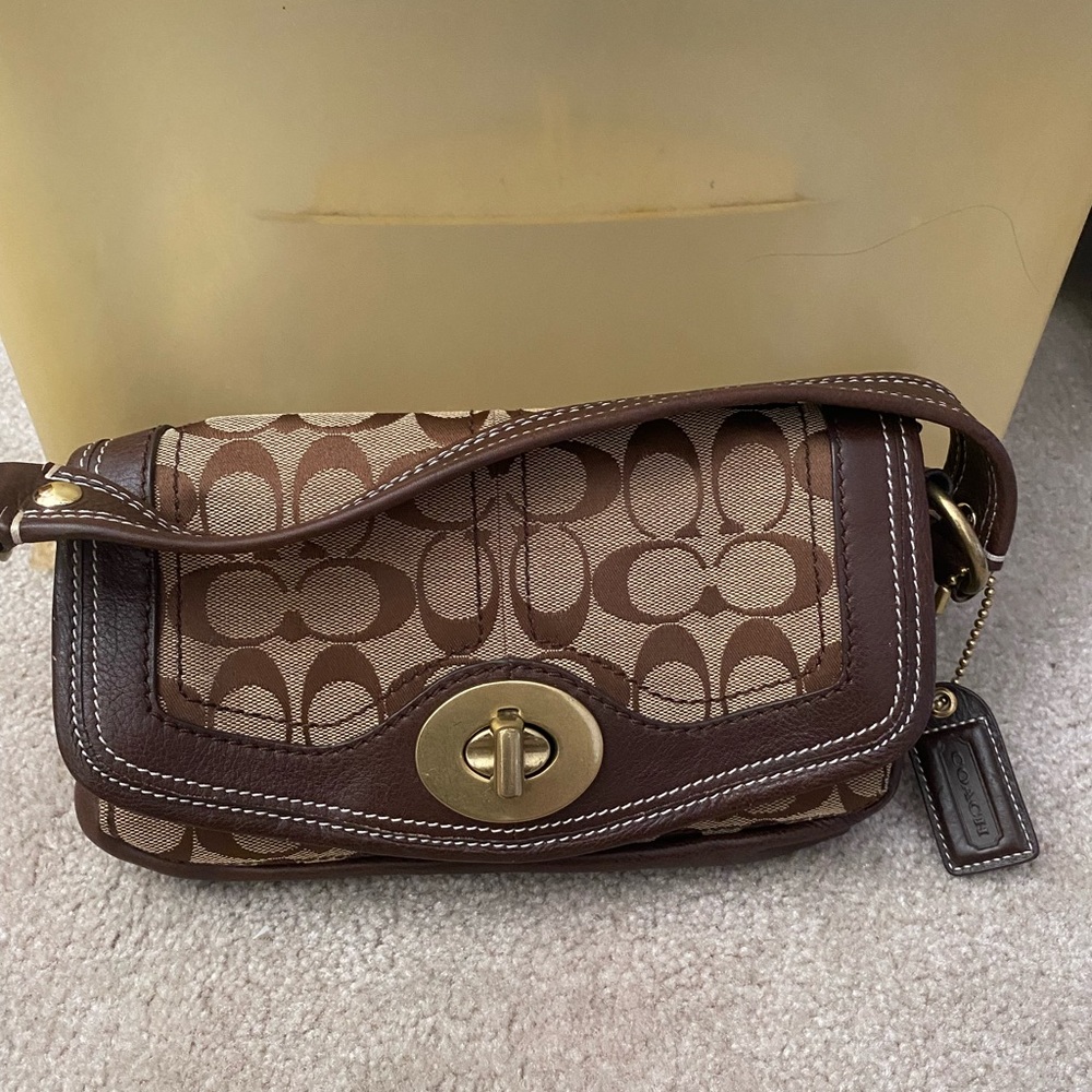 Small brown/tan Coach clutch with strap